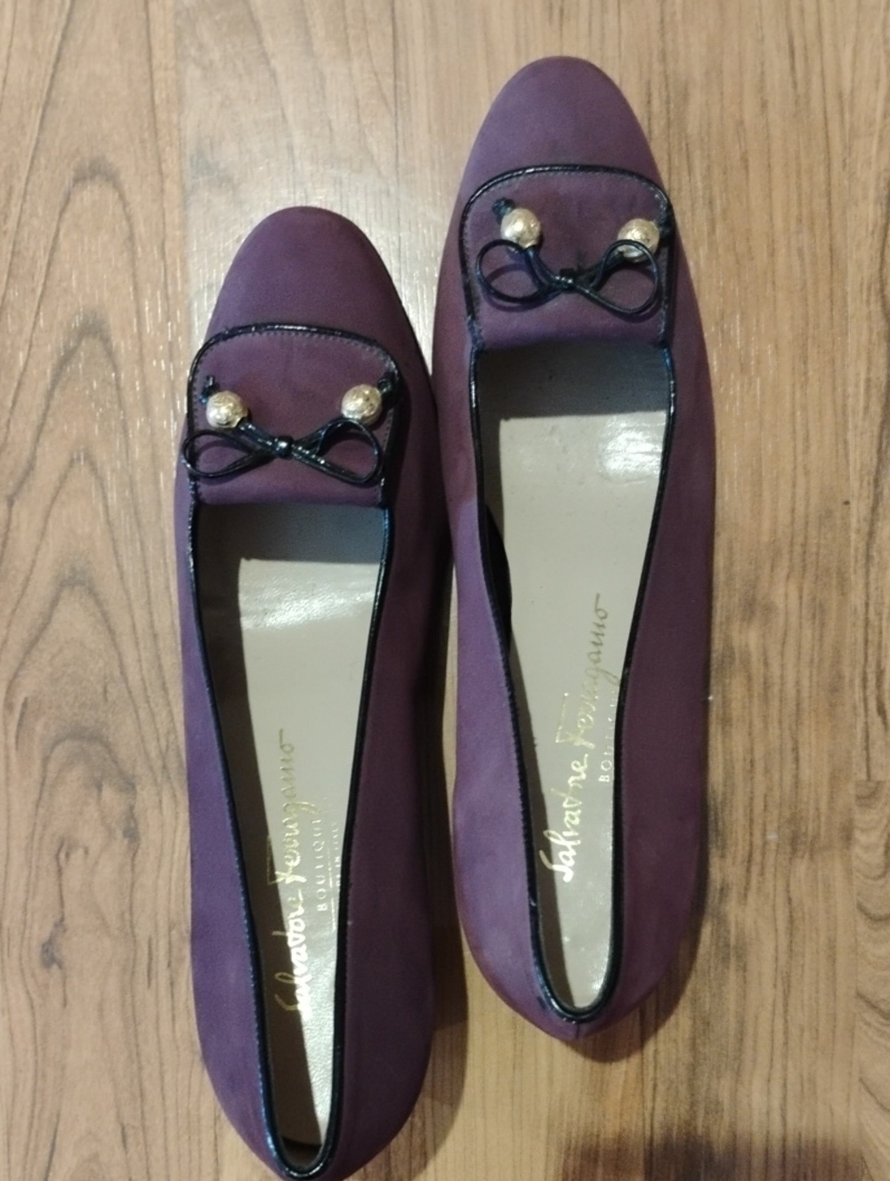 Salvatore Ferragamo Plum Suede Bow-Trim Flats with Gold Accents.